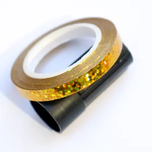 Detailed close-up view of shiny gold holographic balloon ribbon roll for party decorations.