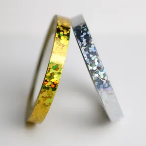Holographic ribbon detail, showing the shiny gold and silver surface texture up close.
