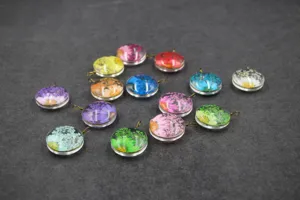 Details of colorful dried flower glass dome pendants, featuring vibrant pressed botanicals.