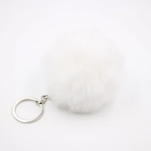 Soft white faux rabbit fur pom pom keychain pendant for handbags and car keys charm detail view.