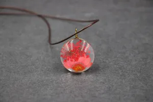 Handmade dried flower resin pendant necklace featuring delicate red floral art details.