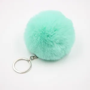 Fluffy mint green faux rabbit fur pom pom keychain, cute bag charm and car key accessory.
