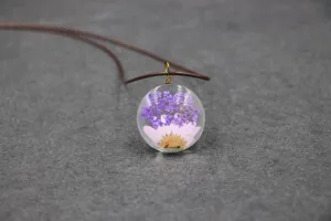 Handmade pressed flower glass pendant necklace featuring purple gypsophila and pink daisy.