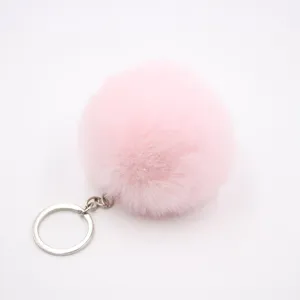 Faux fur pom-pom keychain, soft fluffy ball charm for handbags and car keys in pink.