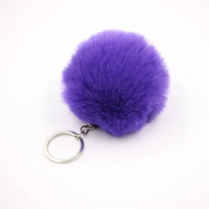Detailed close-up of the soft purple faux fur pom-pom keychain with silver metal ring.