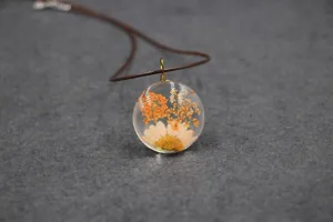 Close-up detail of the dried flower resin pendant necklace showcasing intricate floral design.