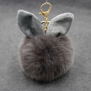 Cute rabbit ear plush pom pom keychain charm, fluffy faux fur bag pendant accessory for women.