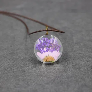Resin dried flower pendant necklace, handmade botanical jewelry with purple and pink florals.