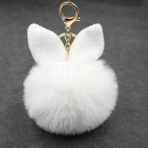 Cute white rabbit ear plush pom-pom keychain fluffy bag charm with gold metal hardware.