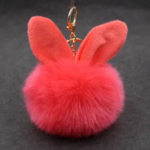 Detailed view of red plush rabbit ear pom pom keychain, cute fluffy bag pendant charm accessory