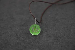Handmade dried flower glass sphere necklace pendant featuring a fresh natural botanical style.