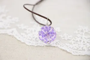 Handmade dried flower glass ball pendant necklace closeup detail showing purple floral design