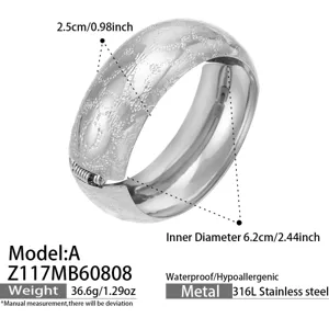 Close-up detail of the wide frosted stainless steel bangle showing precise dimensions and texture.
