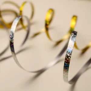 Close-up detail of holographic curly ribbon for party balloon decoration and gift wrapping.
