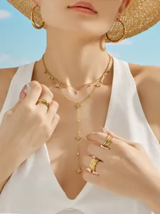 Detailed view of gold layered clover necklace set with sparkling zircon stones and pendant.