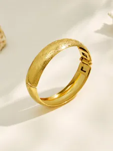 Gold plated stainless steel wide hinged bangle bracelet with frosted floral pattern for women.