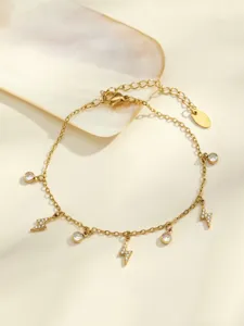 Gold-plated lightning charm bracelet detail view with sparkling zirconia crystal pendants.