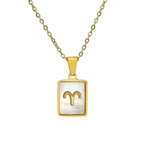 Close-up of Aries zodiac symbol on shell-inlaid rectangular gold pendant necklace