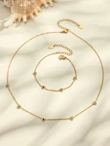 Detailed view of gold-plated titanium steel necklace and bracelet set with colorful heart zircons.