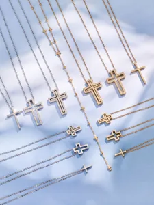 Close-up details of multi-style cross pendant necklaces with pavé zircon and beaded chains.