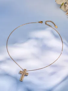 Detail view of a luxury cubic zirconia double cross pendant necklace on a shaded blue background.