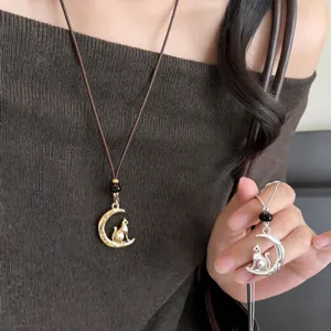 Exquisite moon cat pendant necklace detail, stylish leather cord sweater chain jewelry.
