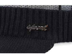 Close-up detail of men's knitted winter hat with black ribbed band and metallic sport logo.