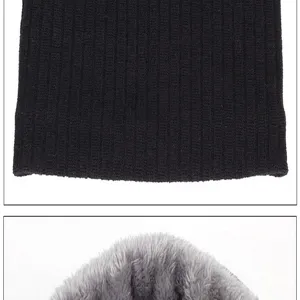 Close-up detail of winter warm neck warmer, black ribbed knit outside with cozy grey fleece inside.