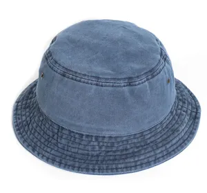Blue washed denim bucket hat detail view, casual flat top style close-up showing texture.