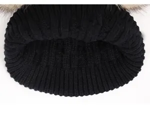 Black knit winter hat detail, double pom pom design, cozy baby hat knit texture close up