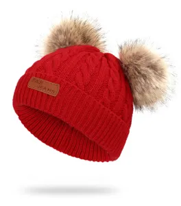 Kids red knit beanie hat with double fluffy faux fur pom poms warm winter baby cap.