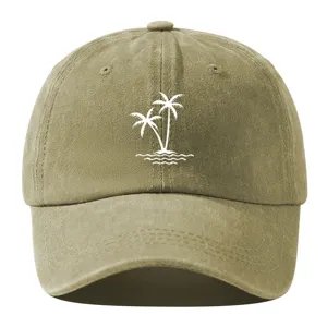 Close-up detail of the washed cotton baseball cap featuring a white palm tree graphic.