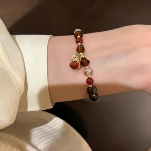 Detail of vintage crystal tiger eye beaded bracelet, New Chinese Maillard style brown wrist jewelry.