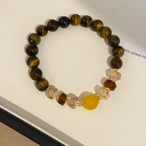 Detailed close-up of tiger eye crystal beaded bracelet in brown tone for women style jewelry.