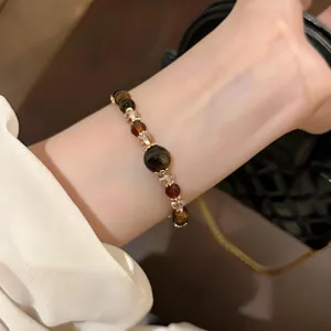 Detail shot of a retro crystal tiger eye beaded bracelet, brown Maillard style jewelry for women.
