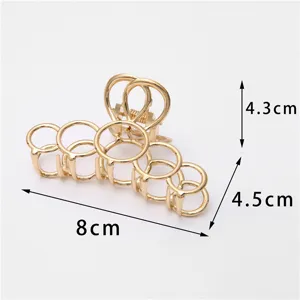 Pinza de pelo de metal dorado con diseño geométrico de cinco anillos huecos, 8cm.