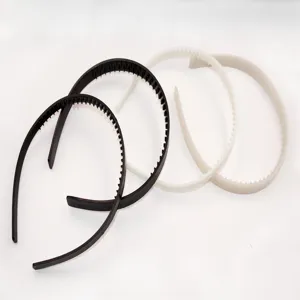 Detailed view of black and white plastic tooth headbands, showcasing the neat teeth design.