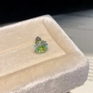 Close-up detail of sparkling colored zircon stud earring displayed in a velvet box.