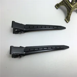 Detailansicht von zwei schwarzen Haarklammern aus Metall mit Belüftungslöchern zum Stylen.