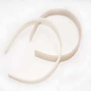 Detailed view of beige plastic tooth headbands, featuring neat inner teeth for secure hair holding.