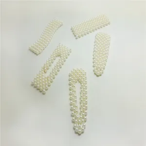 Detailed view of Korean style pearl hair clips set, elegant white pearl hair accessories.