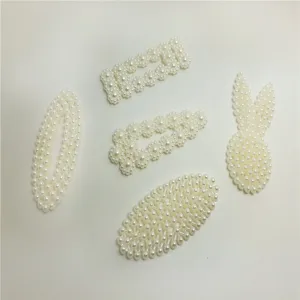 Pearl hair clip detail closeup showing delicate artificial pearl arrangement and cute design shapes.