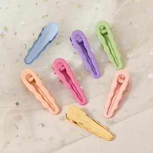 Detail shot of colorful macaron metal duckbill hair clips, soft-touch paint finish, cute wavy edge.
