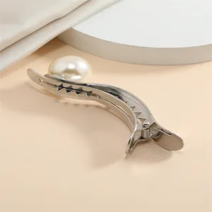 Close-up detail of silver metal hair duckbill clip adorned with a large white pearl.