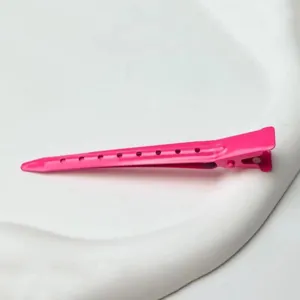 Hot pink metal hair sectioning duckbill clip with ventilation holes, ideal for styling and salon use.