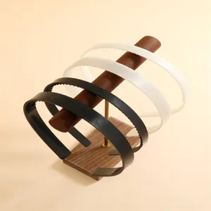 Classic black and white plastic toothed headband, ideal for daily wear and styling.