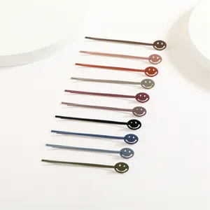 Colorful metal bobby pins with cute cutout smiley face design, perfect for daily styling.