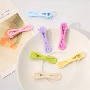 Close up detail of colorful candy hair clips displayed on a white plate, stylish and cute.
