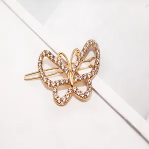Detail shot of exquisite gold rhinestone butterfly hairpin, elegant sparkling hair accessory for women.
