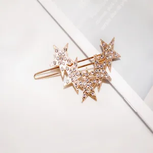 Rhinestone star hair clip detail shot, elegant gold hairpin accessory, sparkling crystal stars.